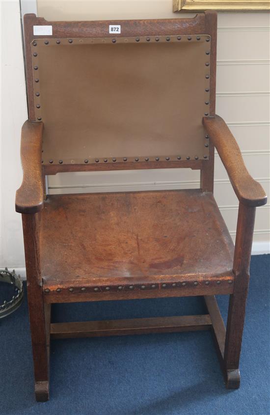 An oak and leather elbow chair